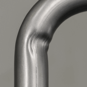 bent metal tube exhibiting manufacturing defects, with wrinkling or collapse along the inner radius
